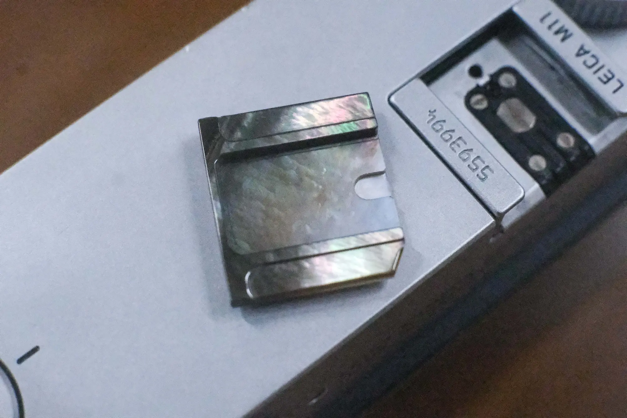 Pink mother-of-pearl shutter button on a camera
